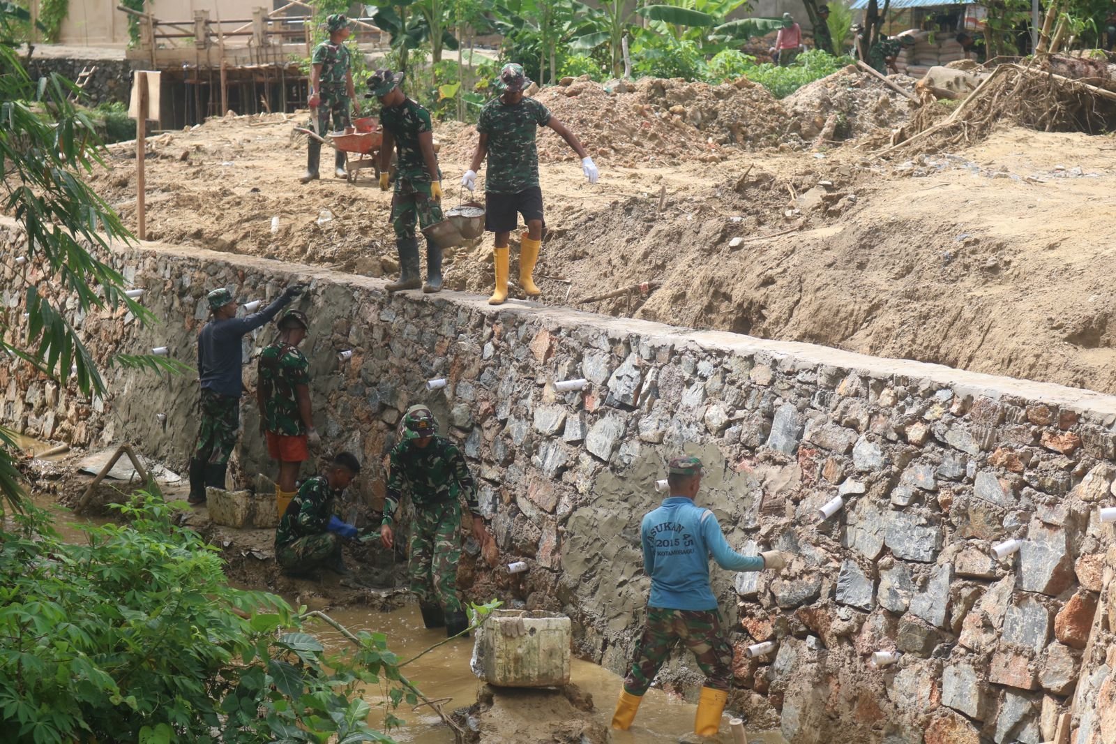 Perkuat Struktur Penahan Tanah, Satgas TMMD 127 Ratakan Semen di Dinding Talud