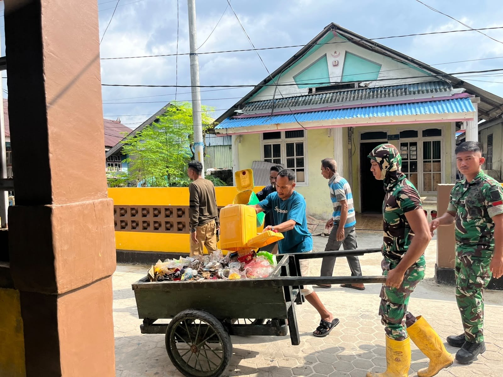 Satgas TMMD dan Warga Bersihkan Tempat Pembuangan Sampah di Desa Umbele